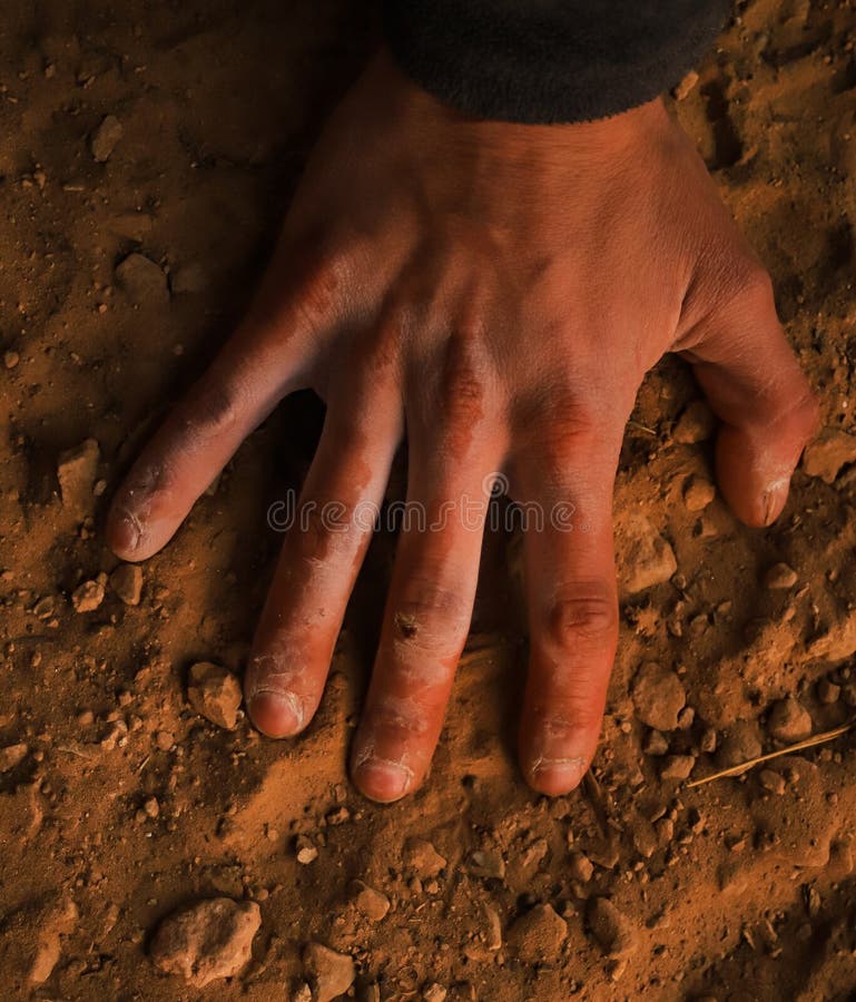 A Hand is on the Ground with the Word on it on it Stock Photo Image