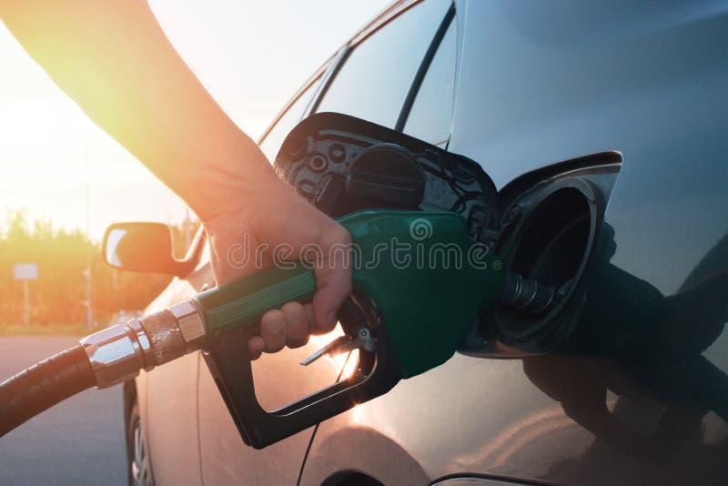 Hand guiding the fuel in the car