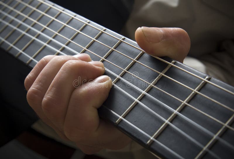 Hand on guitar fingerboard