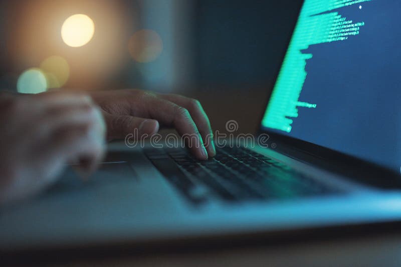 Hand, hacker and typing on laptop at night as thief with malware for hacking database software, hardware virus or stock photography