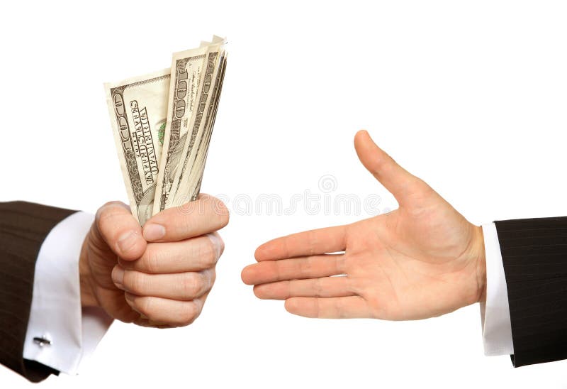 Hand handing over money to another hand stock image