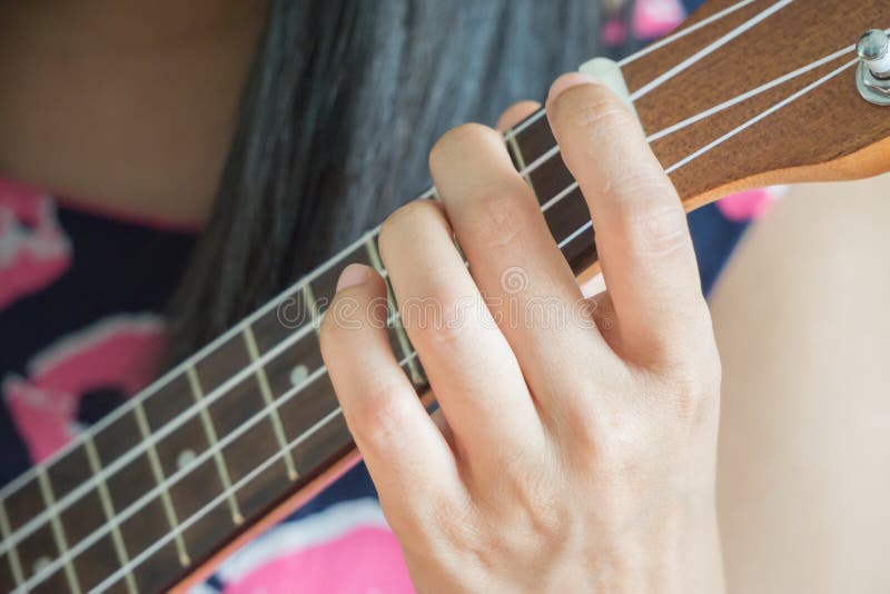Hand het spelen gitaar of Ukelelesnaar royalty-vrije stock foto Hand het spelen gitaar of Ukelelesnaar royalty-vrije stock foto
