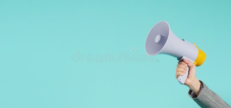 Hand is hold megaphone and wear grey suit on green or mint or Tiffany Blue  background