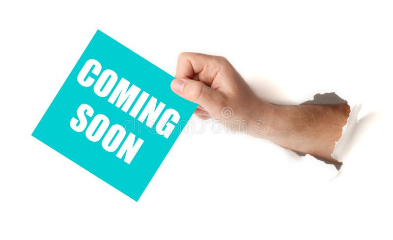Hand hold paper with coming soon. Announcement of launch stock image