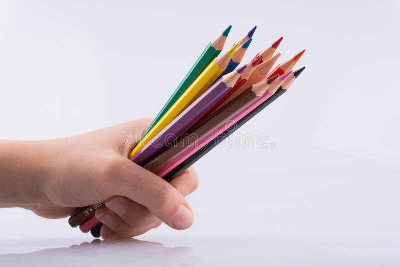 Hand holdin pencils