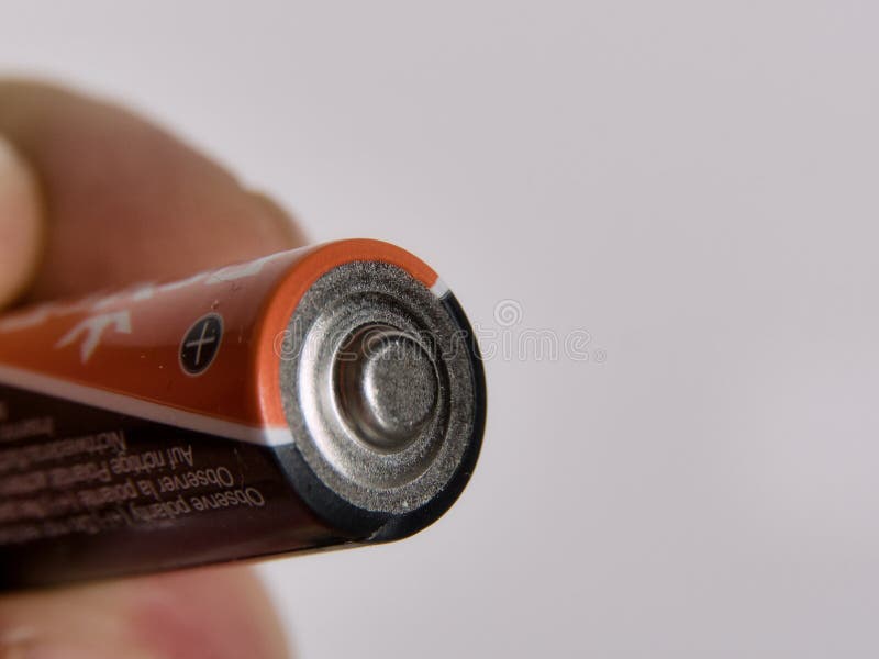 Hand Holding AA Batterie, Isolated on White Background Stock Image