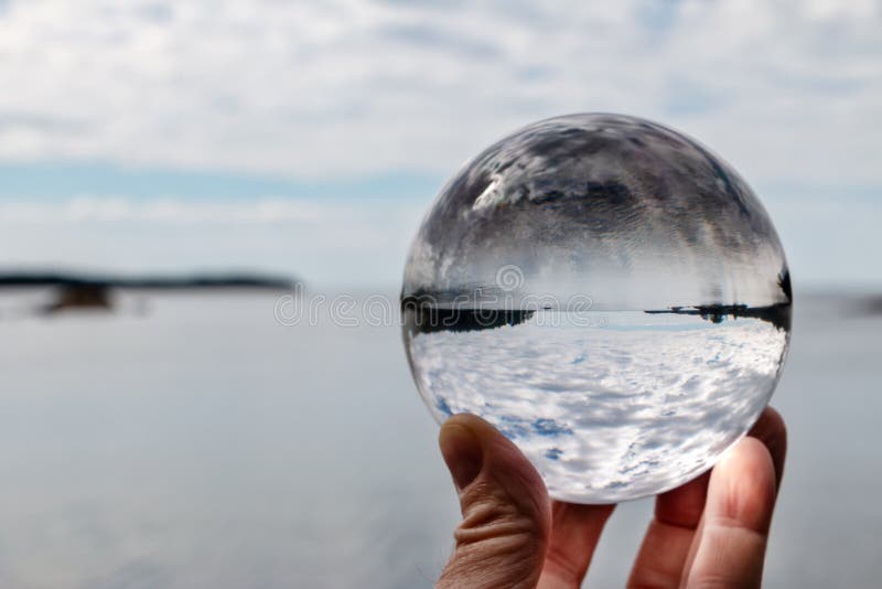 Hand Holding Acrylic Crystal Ball by a Lake Stock Photo Image of