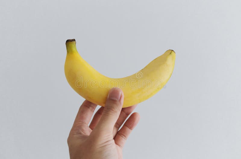 Hand holding banana, on white background stock image Hand holding banana, on white background stock image