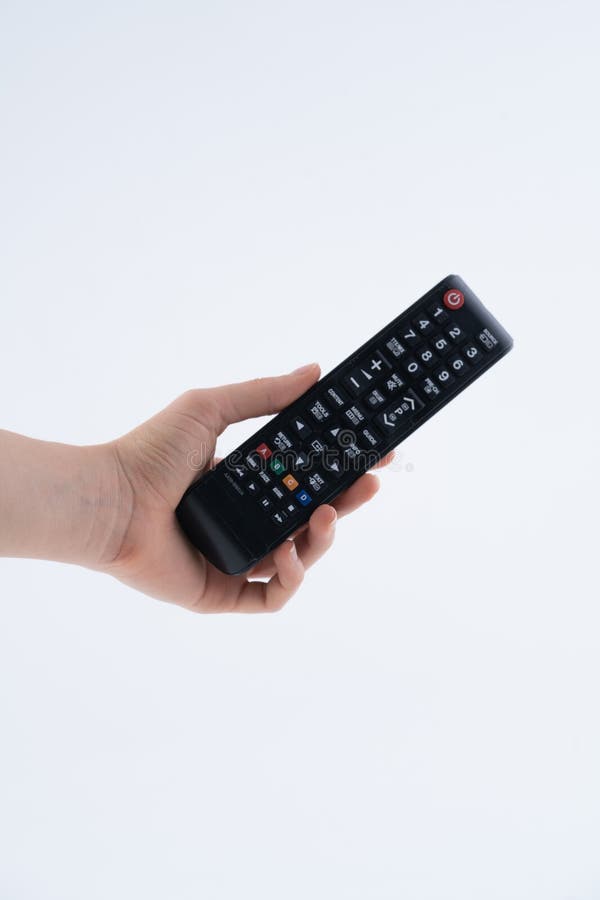 Hand Holding Black Remote Control with Multiple Buttons royalty free stock photos