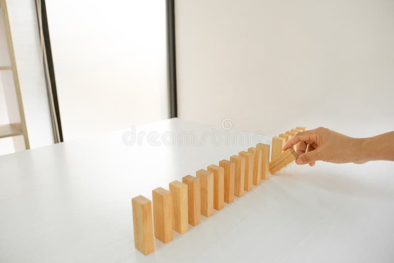 Hand holding blocks wood game, Concept Risk of management and strategy plan, growth business success process and team work.