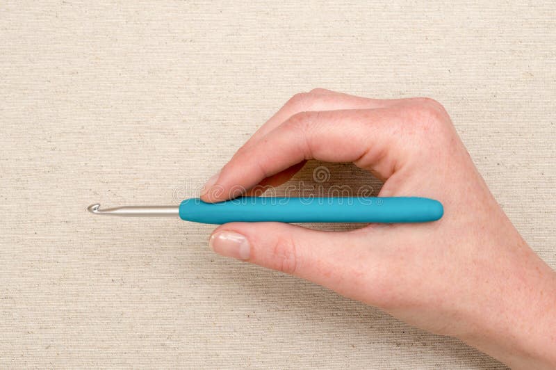 Hand Holding a BlueHandled Crochet Hook Stock Image Image of