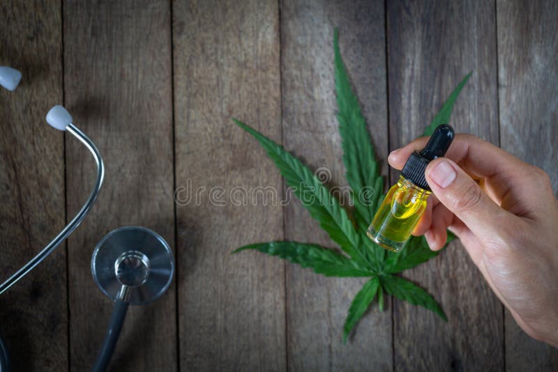 Hand holding bottle of Cannabis oil in pipette, natural herb, esearching hemp oil extracts for medical purposes, alternative stock photos Hand holding bottle of Cannabis oil in pipette, natural herb, esearching hemp oil extracts for medical purposes, alternative stock photos