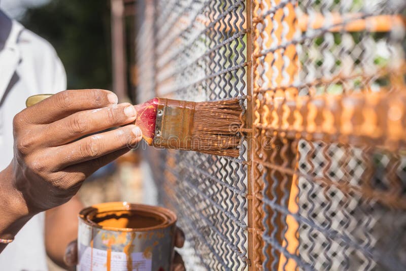 Hand Holding Brush and Painting on the Metal Grid Stock Image Image