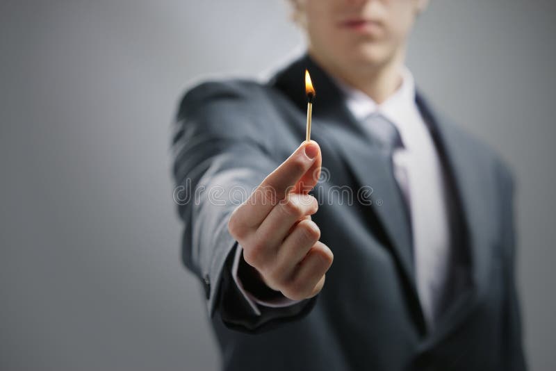 Hand holding a burning match