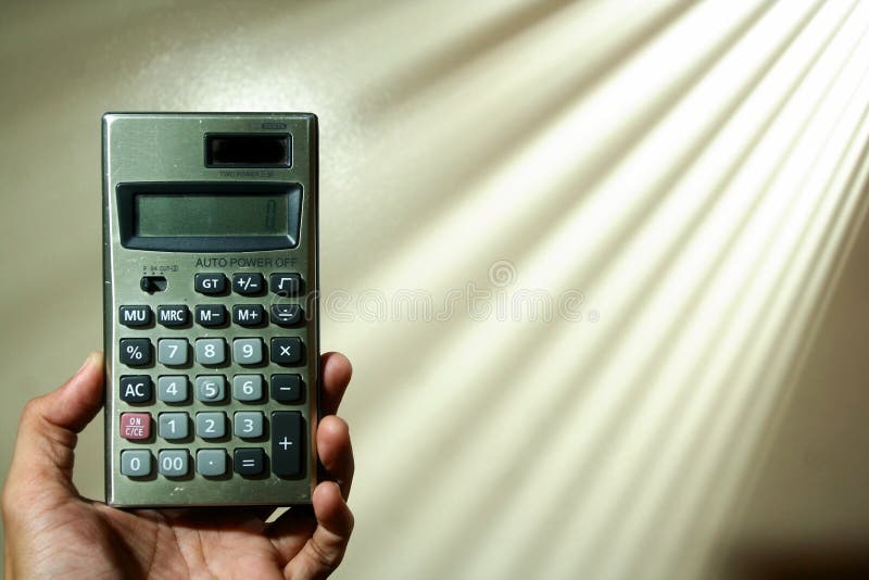 Hand holding a calculator stock photo. Image of computation 56601528