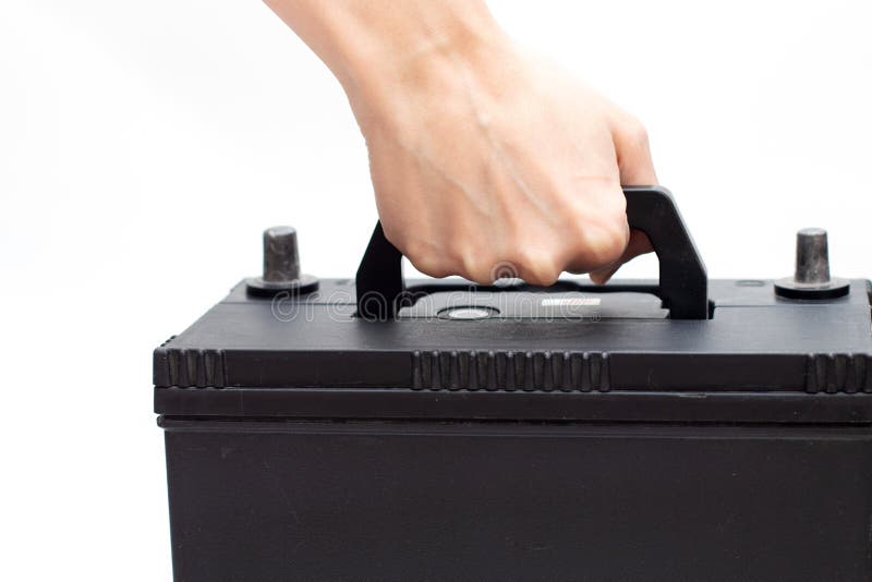 Hand Holding Car Battery for Replacement or Changing Battery Stock
