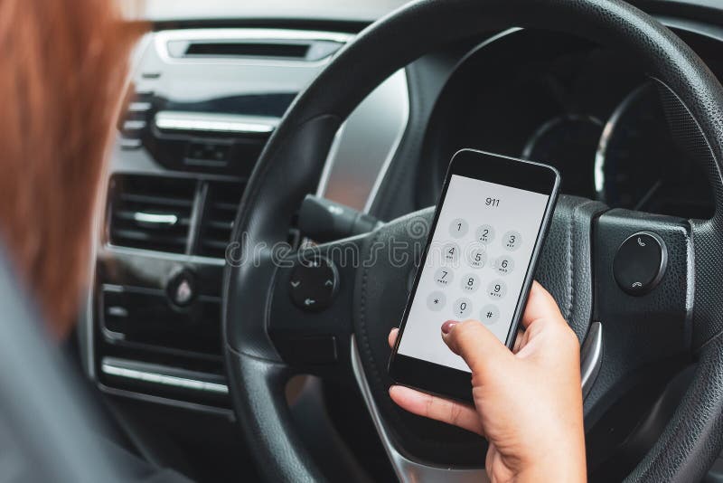 Hand Holding Cell Phone with Emergency Number 911 in Car Stock Image