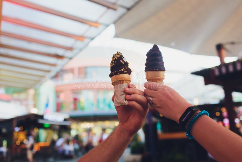 Hand holding chocolate triple scoop ice cream. royalty free stock image