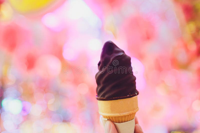 Hand holding chocolate triple scoop ice cream. royalty free stock photo