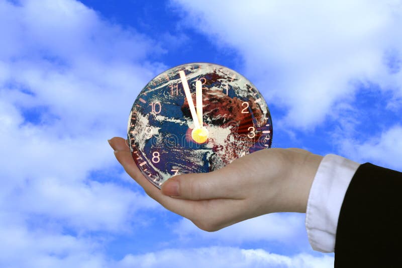 Hand holding globe clock stock photo. Image of hand, international