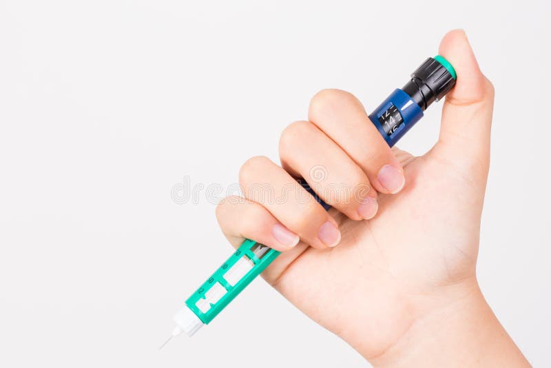 Hand holding insulin pen