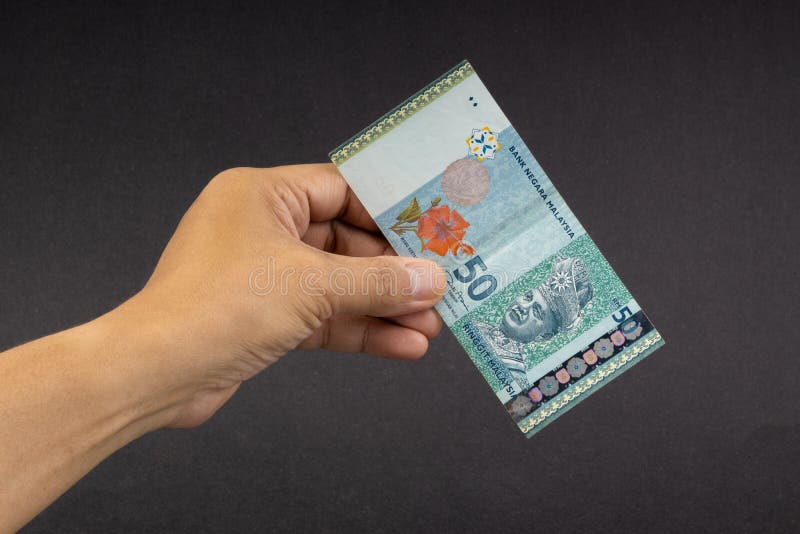 Hand Holding Malaysia Ringgit MYR Currency Bank Notes. Stock Photo ...