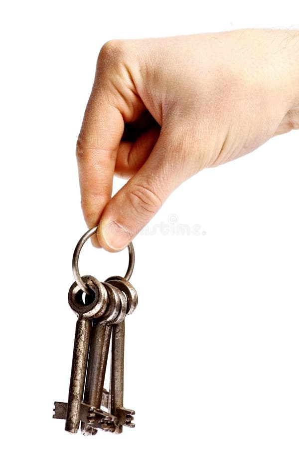Hand holding old rusty keys on a ring stock photo