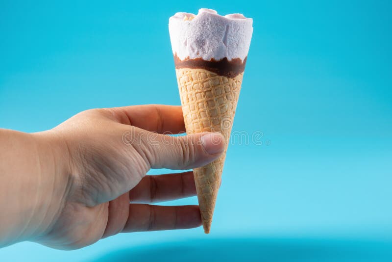 Peanut Ice Cream Cone Upside Down on Blue Background Stock Photo