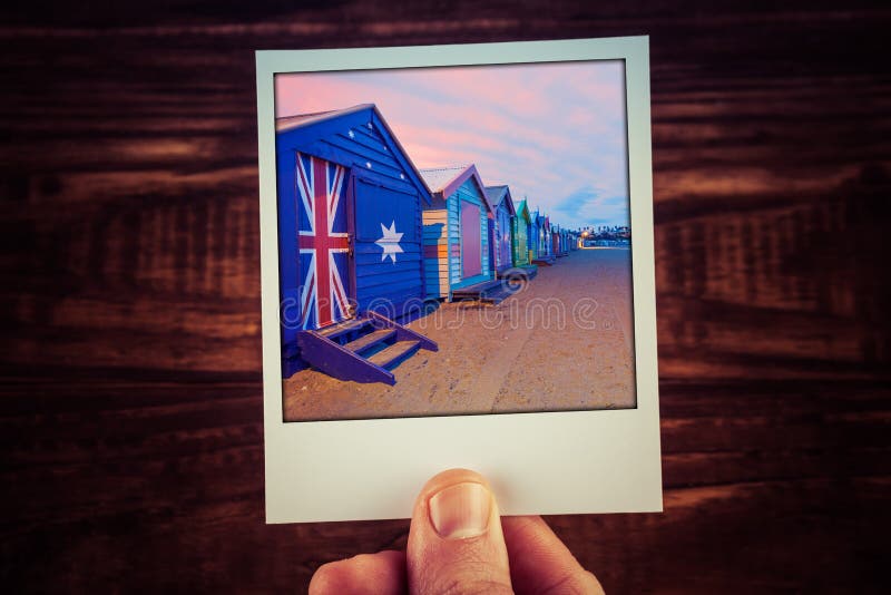Hand holding polaroid photograph of famous Brighton Beach Boxes in Melbourne, Australia. Travel memories scrapbooking of good times with copy space