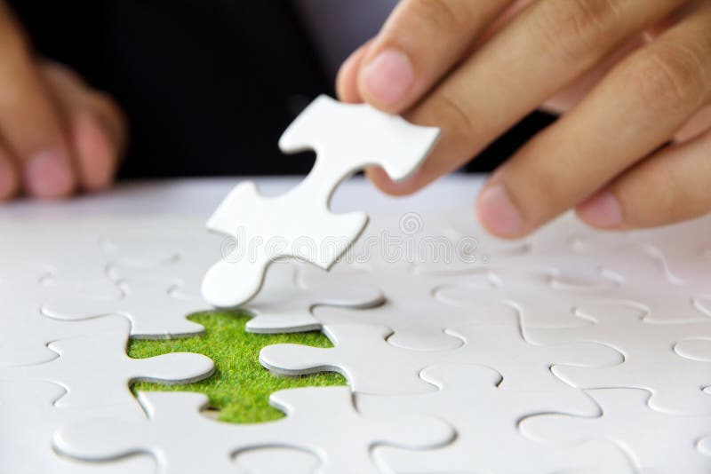 Hand holding a puzzle piece royalty free stock images