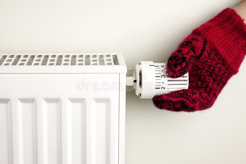 Hand holding radiator thermostat royalty free stock photos