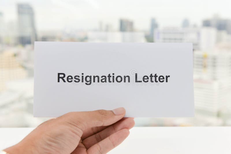 Hand is holding the Resignation letter royalty free stock image