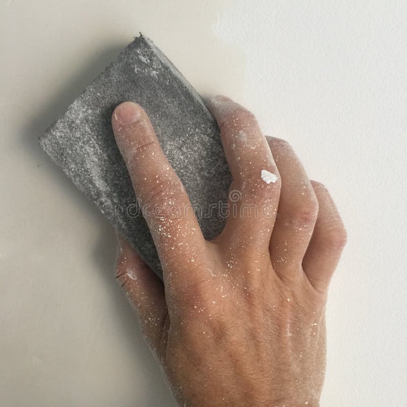 Hand holding sand paper block
