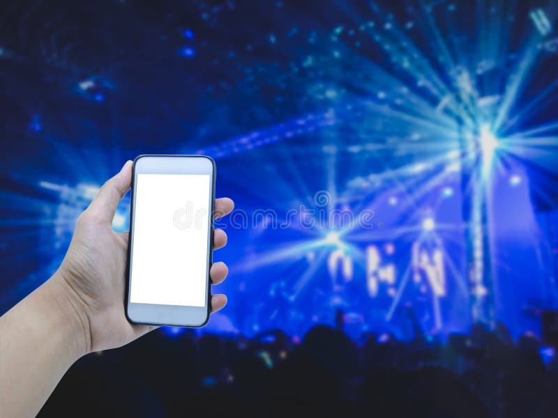 Hand holding smart phone on blurred concert royalty free stock photo Hand holding smart phone on blurred concert royalty free stock photo