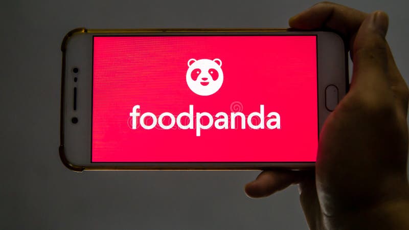 Bangi, Malaysia - October 10, 2019: Hand holding a smartphone with the FoodPanda application logo on the screen. FoodPanda is a very famous online food delivery brand