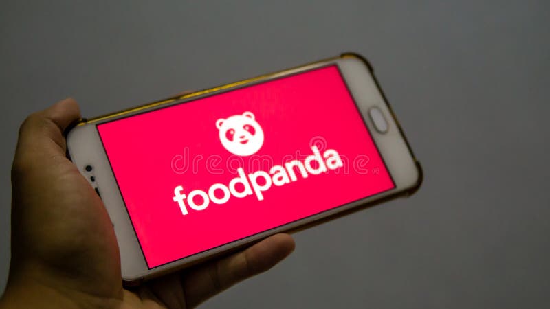 Bangi, Malaysia - October 10, 2019: Hand holding a smartphone with the FoodPanda application logo on the screen. FoodPanda is a very famous online food delivery brand