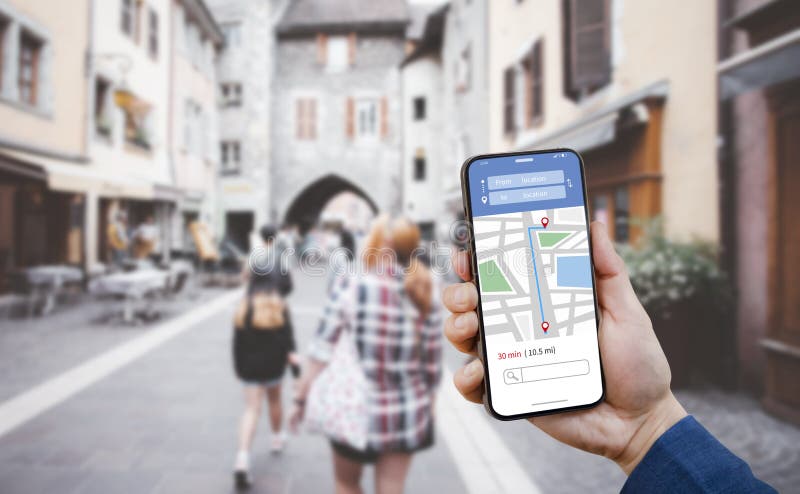 Hand holding Smartphone with Tourists using GPS map navigation apps on smartphone, blurred road background close up concept of onl stock images