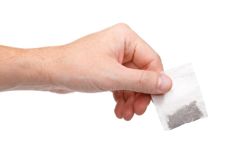 Hand holding teabag isolated on white background