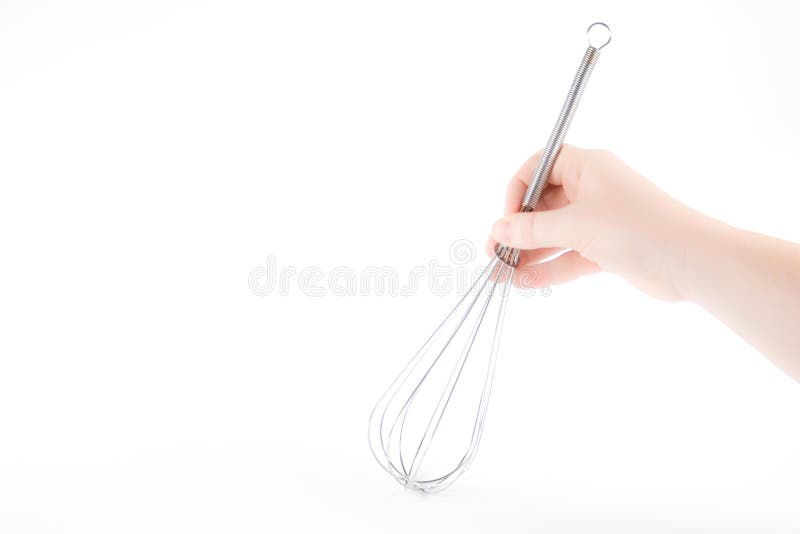 Hand holding a whisk