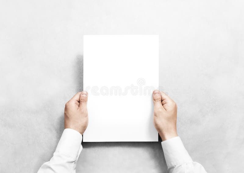 Hand holding white blank paper sheet mockup,. stock image