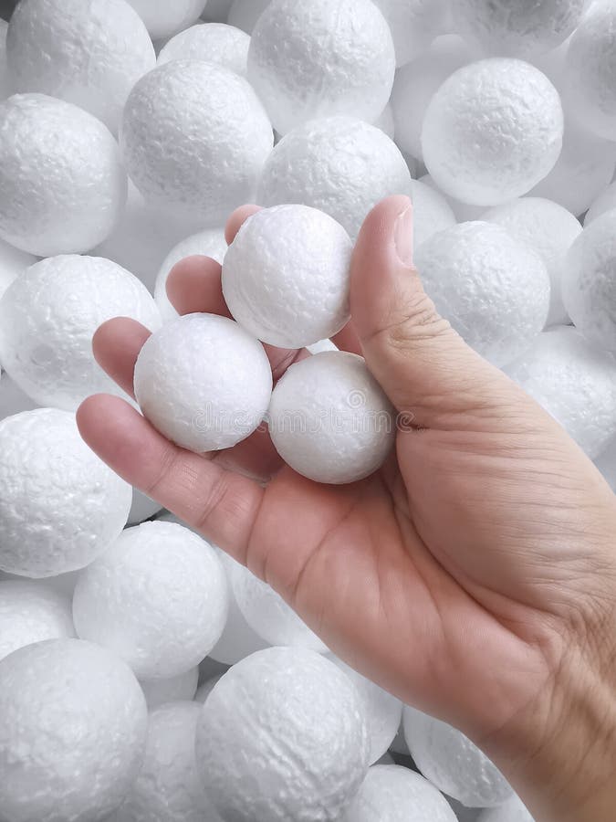 Hand Holding White Polystyrene Foam Beads Ball Drop From Styrofoam