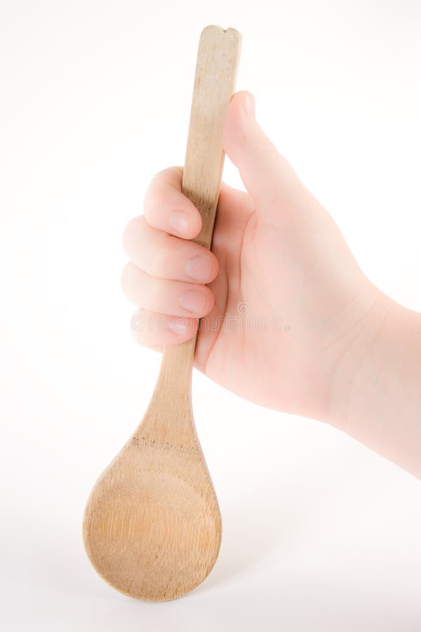 Hand holding a wood spoon
