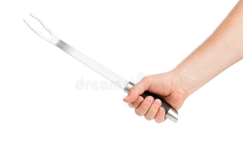 A hand holds a barbecue fork