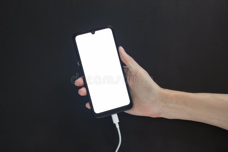 Hand Holds a Charging Smartphone with a Light Screen on a Black Background Stock Image Image