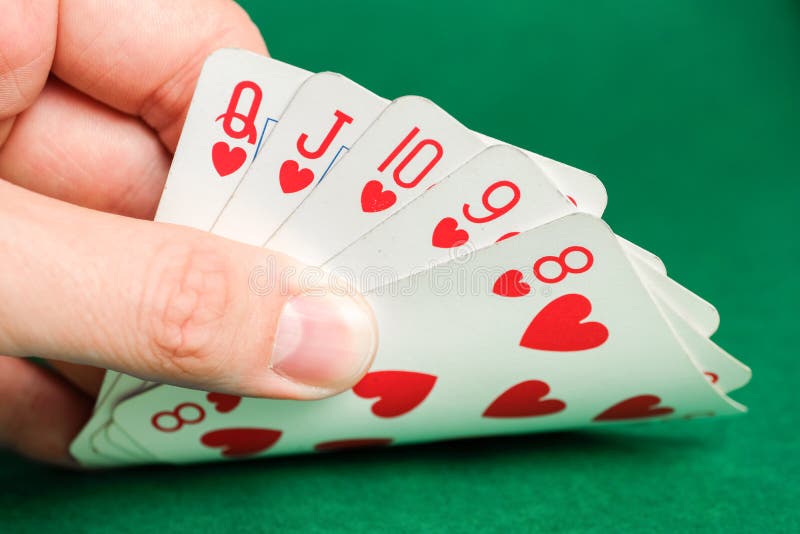 Hand Holds a Combination in Poker Straight Flush on a Green