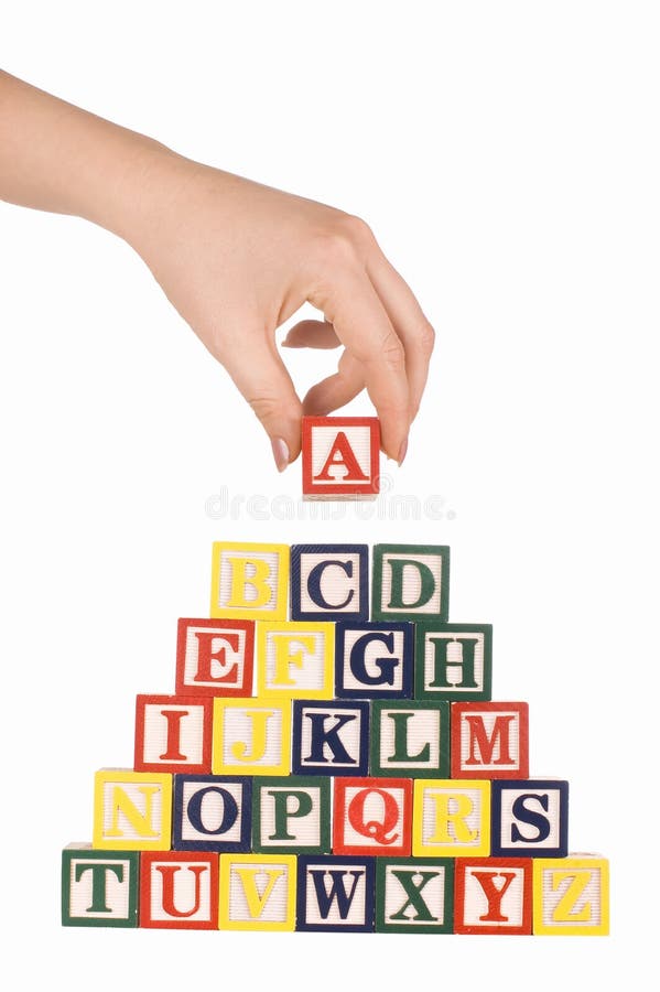 The hand holds a cube with letters