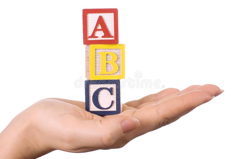 Hand holds a cube with letters