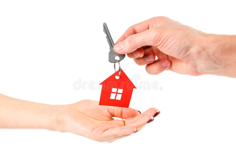 The hand holds the keys with the red house keychain. Purchase of royalty free stock images The hand holds the keys with the red house keychain. Purchase of royalty free stock images