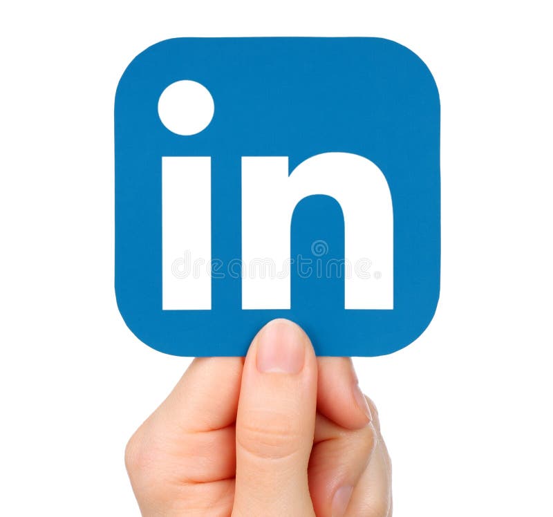 Hand holds LinkedIn icon on white background