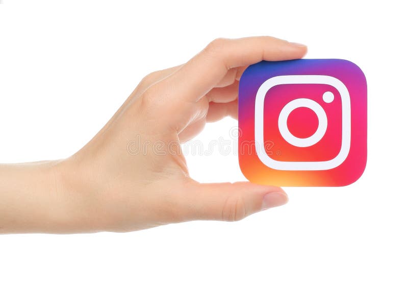 Kiev, Ukraine - May 17, 2016: Hand holds new Instagram logo printed on paper, on white background. Instagram is an online mobile photo-sharing, video-sharing service.